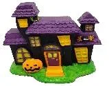 Resin aquarium ornament shaped as a purple Halloween-style haunted house with a jack-o'-lantern accent on the lawn