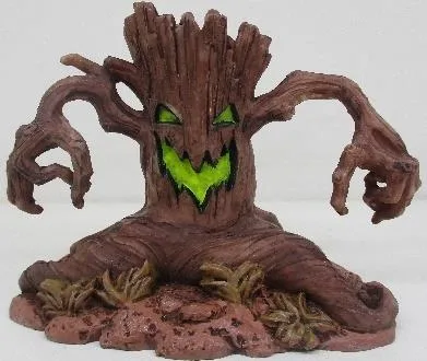 Resin aquarium ornament shaped as a spooky tree stump with a glowing green carved face and clawed branches